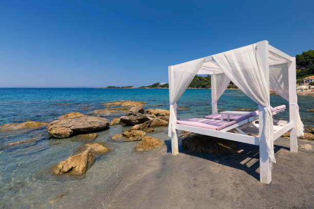 istock Luxury white bed on a beach in the Mediterranean 891602100