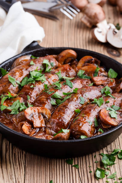 istock Sausages with onion and mushrooms gravy 891605716