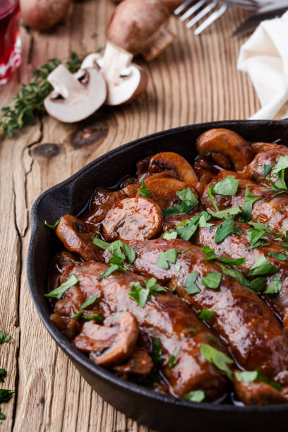 istock Sausages with onion and mushrooms gravy 891605930