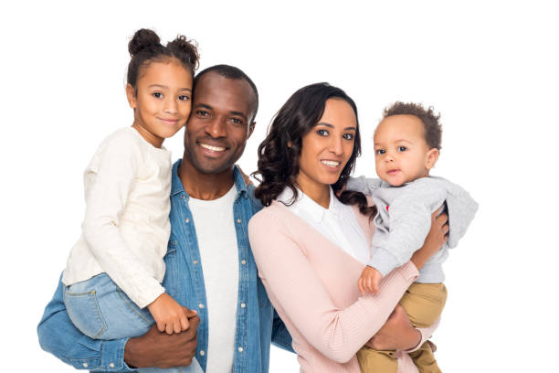 happy african american family with two kids happy african american parents holding cute little kids and smiling at camera isolated on white the black womens expo stock pictures, royalty-free photos & images