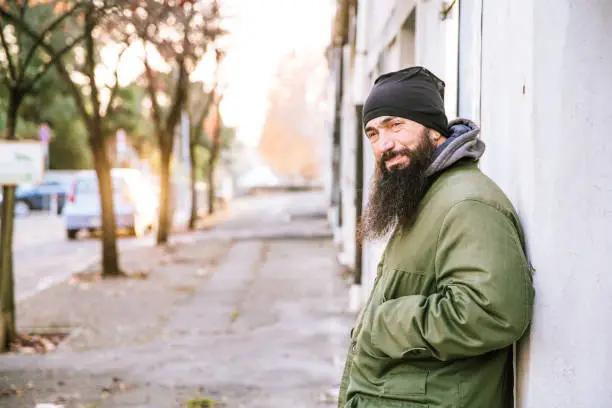 Photo of Portrait of an Adult Homeless Man on City Street