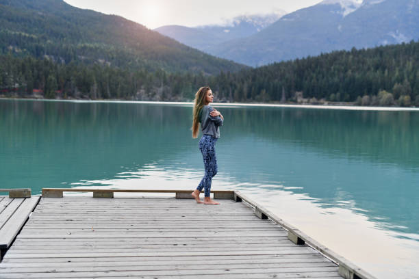 istock Young woman enjoying lake and mountain view 891609642
