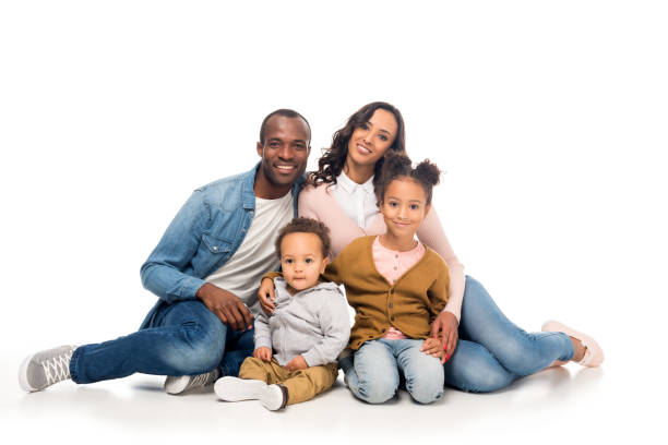 happy african american family with two kids happy african american family with two children sitting together and smiling at camera isolated on white the black womens expo stock pictures, royalty-free photos & images