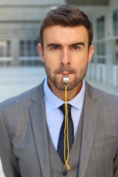 istock Businessman blowing a whistle isolated 891609776