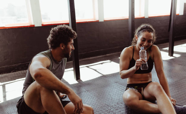 istock Couple relaxing after workout session at gym 891618976