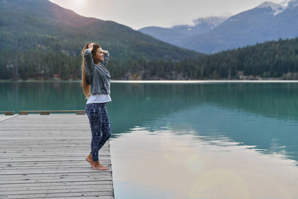 istock Young woman enjoying lake and mountain view 891619084