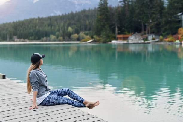 istock Young woman enjoying lake and mountain view 891621986