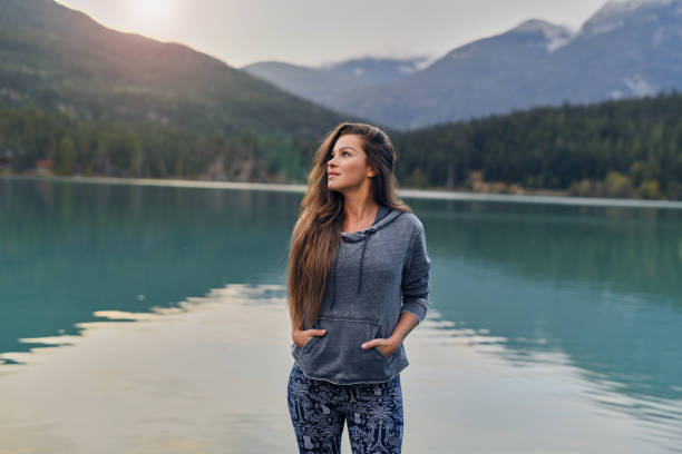Shoot of young woman enjoying lake and mountain view
