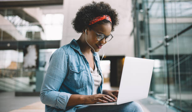 istock Smiling African student studying for an exam on campus 891625526