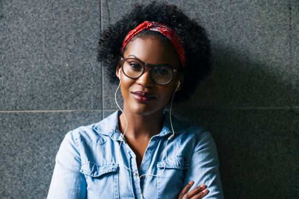 istock Confident young woman standing with her arms crossed 891629990