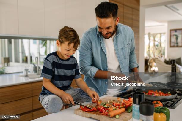 Father And Son Preparing Food In Kitchen Stock Photo - Download Image Now - Cooking, Family, Father