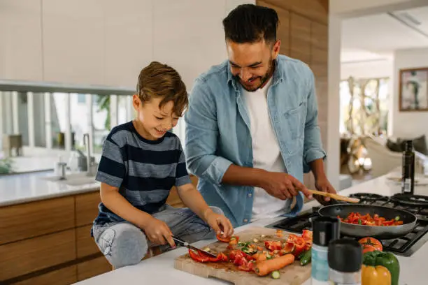 Photo of Father and son preparing food in kitchen
