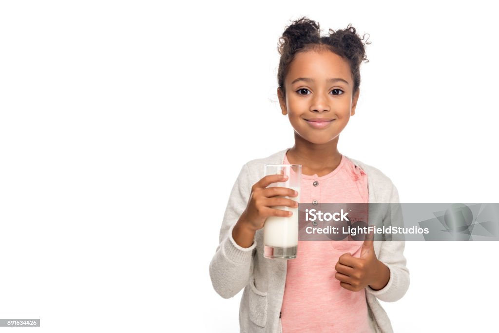 child drinking milk cute african american child drinking milk and showing thumb up isolated on white Milk Stock Photo
