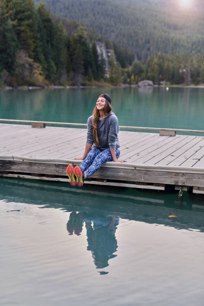 istock Young woman enjoying lake and mountain view 891634726
