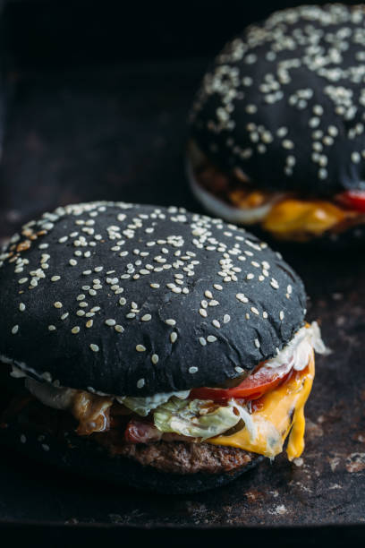 istock Black burger with meat and onion rings 891637494
