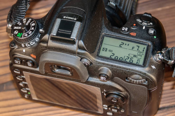 istock Professional digital photo camera on wooden background close-up 891639638