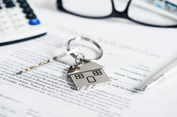 istock Mortgage loan agreement application with house shaped keyring 891641714