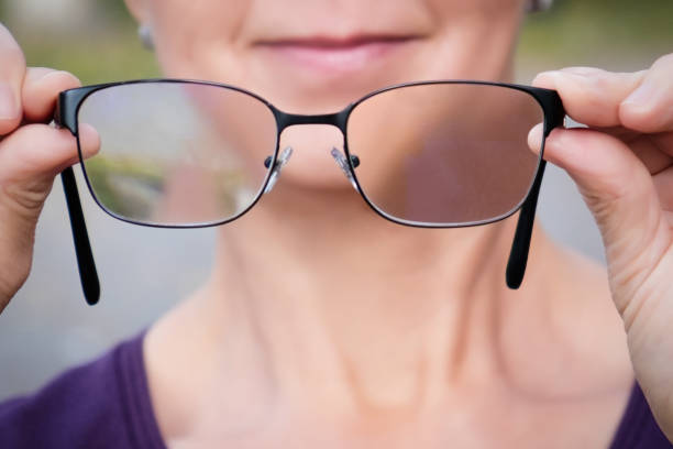 istock Mature woman holding a progressive glasses 891644224