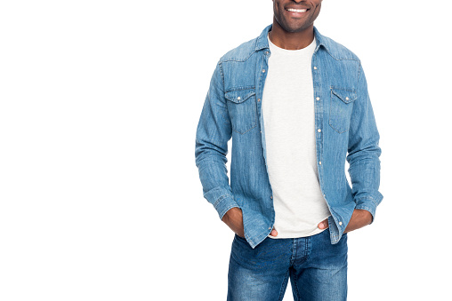 cropped shot of smiling african american man standing with hands in pockets isolated on white