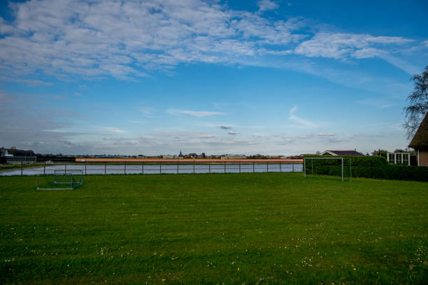 istock green landscape view with grass water and blue sky 891663282