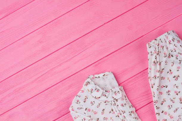 istock Girls' clothes on pink table 891668376