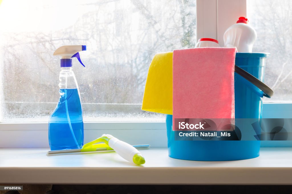 Bucket Spray And Squeegee For Window Cleaning On The Window Sill Stock  Photo - Download Image Now - iStock