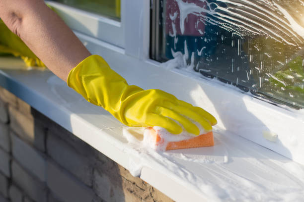 istock Cleaner washes a window sill outside . 891685852
