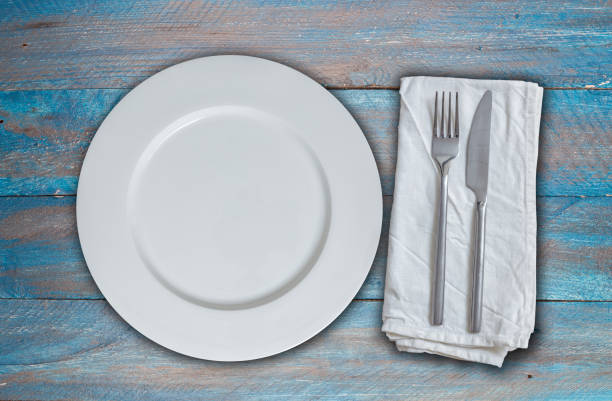 istock Empty dish and cutlery on blue shabby chic wood 891697700