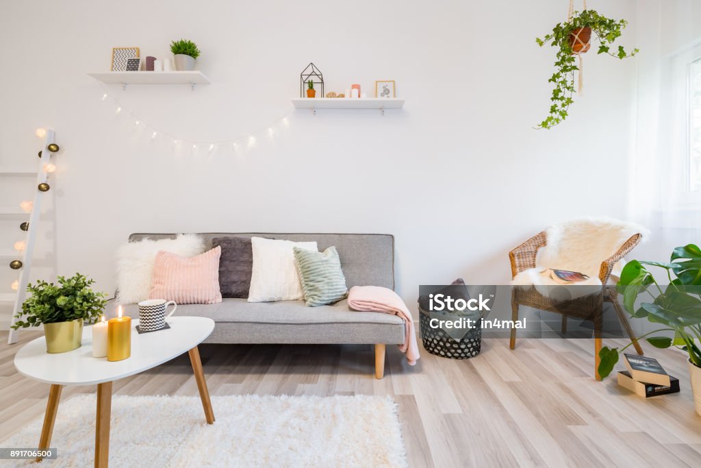 Home interior with gray couch Home interior with gray couch, coffee tabe and wicker chair Candle Stock Photo