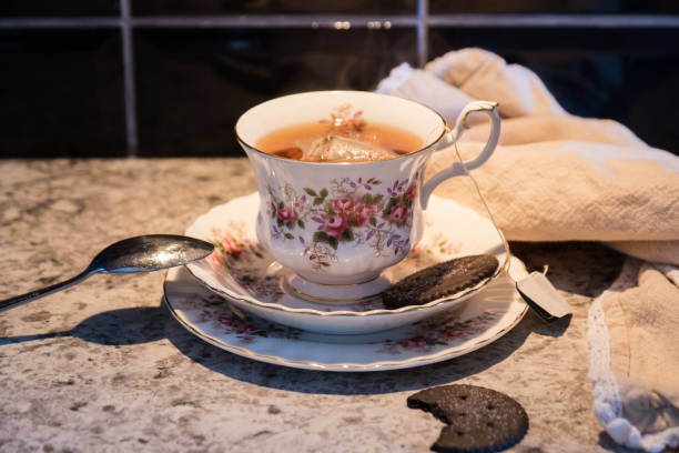 A Steaming Hot Tea With a Couple Cookies stock photo