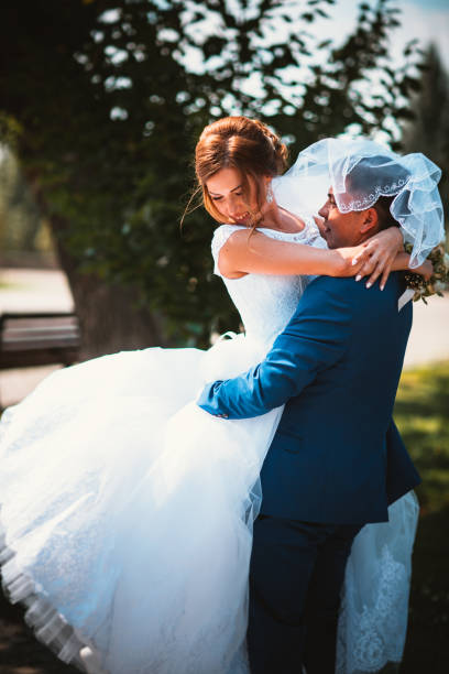istock couple groom and bride on a park background in full growth 891712764