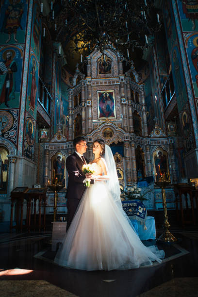 istock young couple groom and bride on church background 891724724