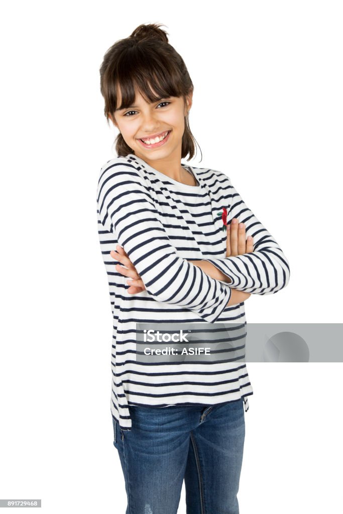 Little girl with arms crossed Portrait of little happy girl in striped t-shirt and blue jeans standing with arms crossed. Isolated on white Cheerful Stock Photo