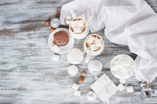 istock Cups with cacao and marshmallow, cupcakes and different Christmas decorations 891733028