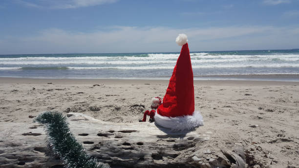 istock Santa Hat at the beach with miniature Santa Klaus 891740626