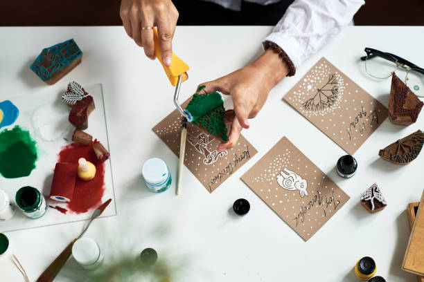 istock Woman using stamps for Christmas card decoration 891746252