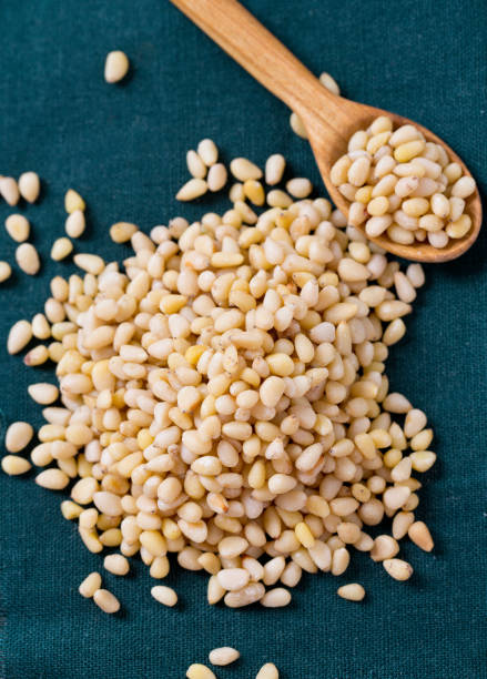 istock pine nuts in a wooden spoon 891746926