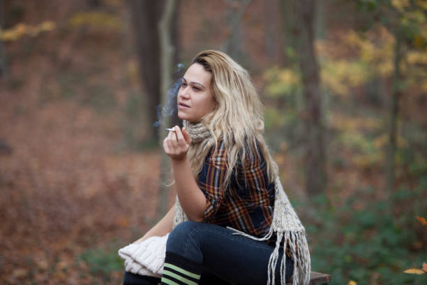 istock woman in cigarette in forest 891754158