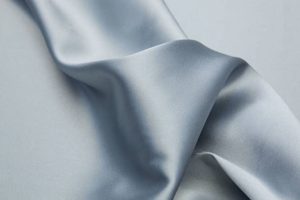 Wavy textile background Wavy satin fabric texture closeupWavy satin fabric texture closeup chiffon stock pictures, royalty-free photos & images