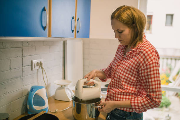 istock Young woman cooking in the kitchen 891769384