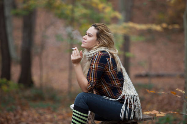 istock woman in cigarette in forest 891772058