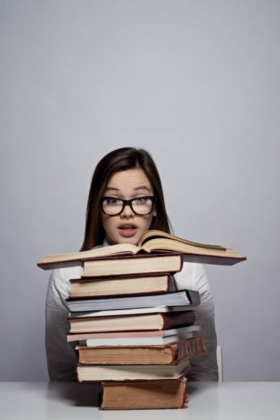 istock Puzzled student reading scientific literature before exam 891772332