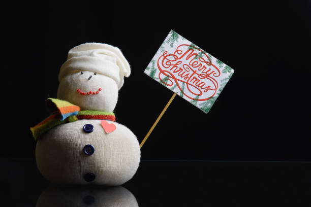 istock Snowman, paperboard sign on a stick, text “Merry Christmas!” 891772496