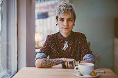 Tattooed woman in a cafe