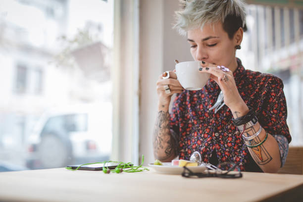 istock Tattooed woman drinking coffee 891791882
