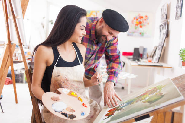 istock Fine art student working with teacher in atelier 891806940