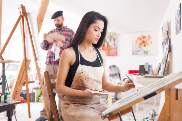 istock Female fine artist drawing in studio 891806946