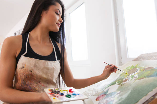 istock Female artist working in studio 891806958