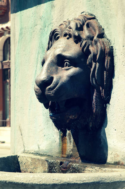 istock Brass fountain statue of a lion head 891807246