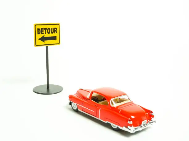 Photo of The mark of the detour and red classic car. white background